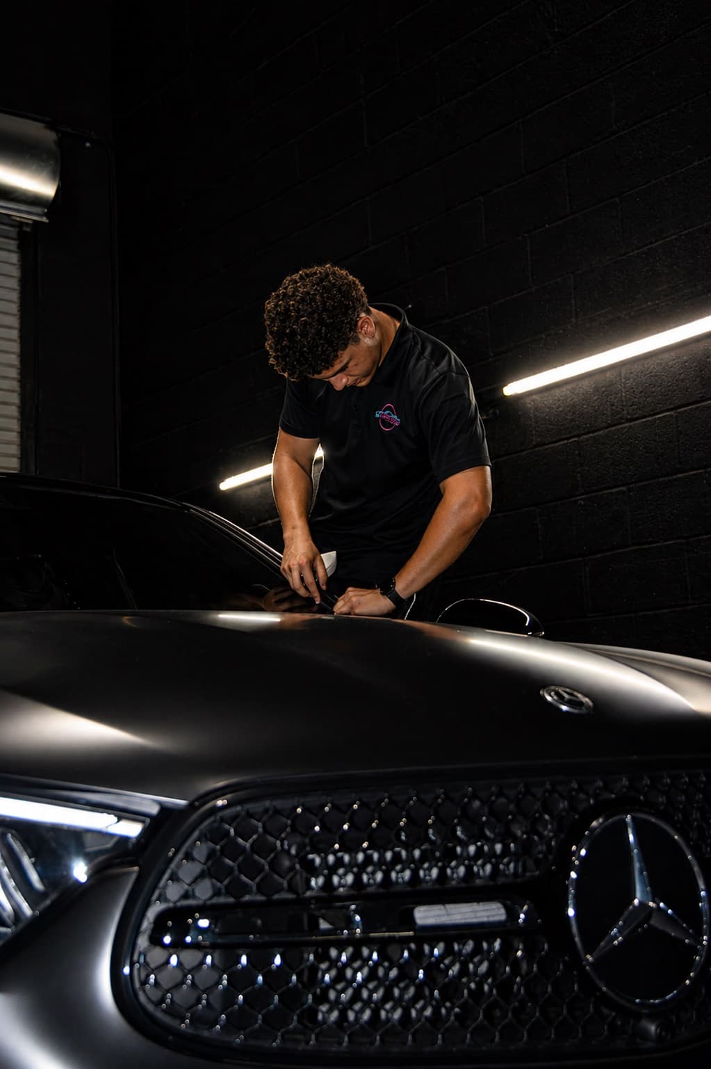 Dr. Tints Miami technician applying film to Mercedes-Benz