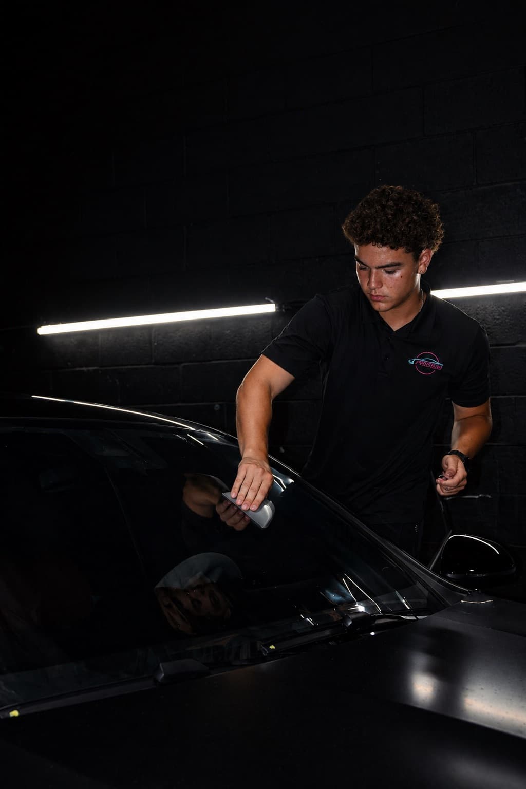 Dr. Tints Miami technician smoothing ceramic window film onto car